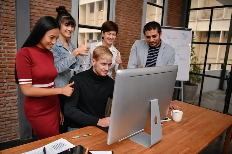 Team reviewing email campaign results on computer